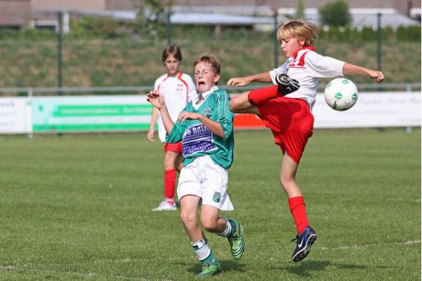 two kids play football
